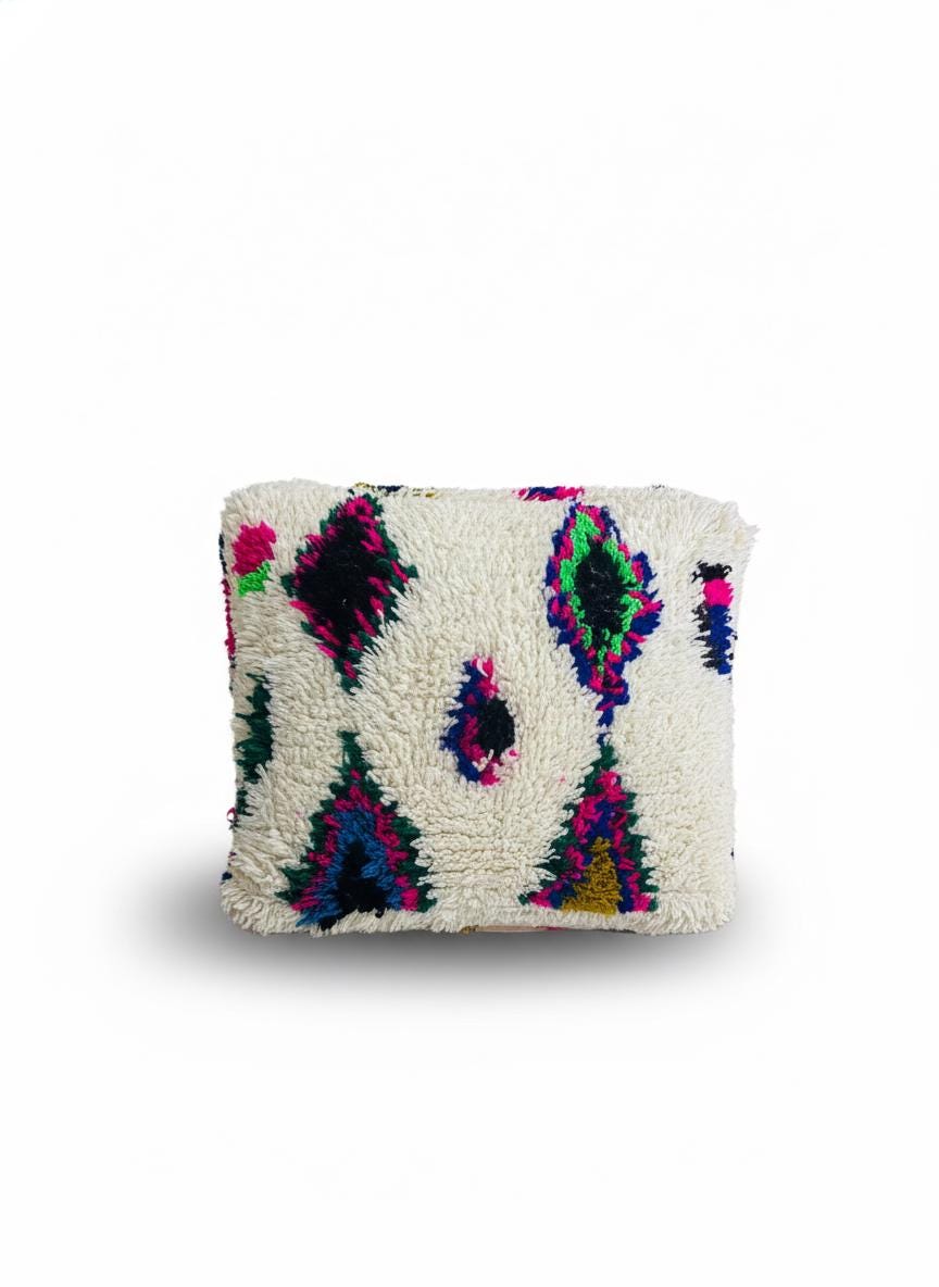 Moroccan wool pouf with vibrant geometric motifs