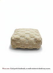 Beige Berber Azar pouf with textured wool pattern on white background