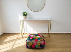 Colorful Berber pouffe displayed in a modern room with natural light.