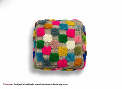 Top view of handmade Moroccan Ider pouffe with colorful wool squares.