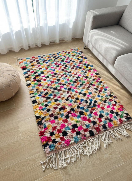 Multicolor Moroccan wool rug on wooden floor