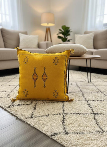 Mustard yellow Moroccan Sabra pillow on cream rug