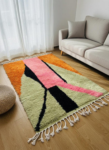 Multicolor Moroccan rug with graphic geometric lines beside sofa