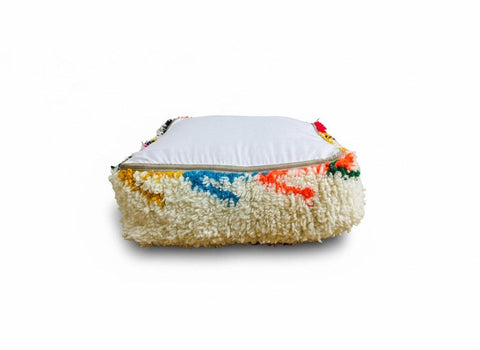 Handmade Moroccan wool pouf with colorful Berber embroidery