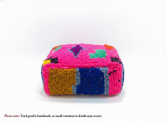 Fuchsia Berber Mazin pouf with colorful geometric patterns.
