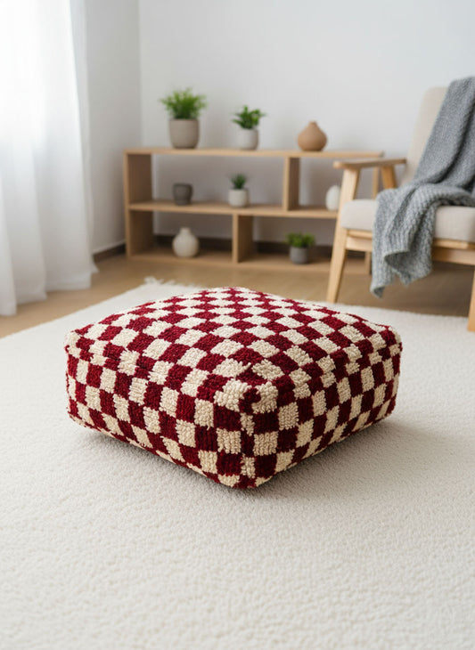 Fuchsia and ivory Moroccan floor pouf on a light textured rug in a modern room