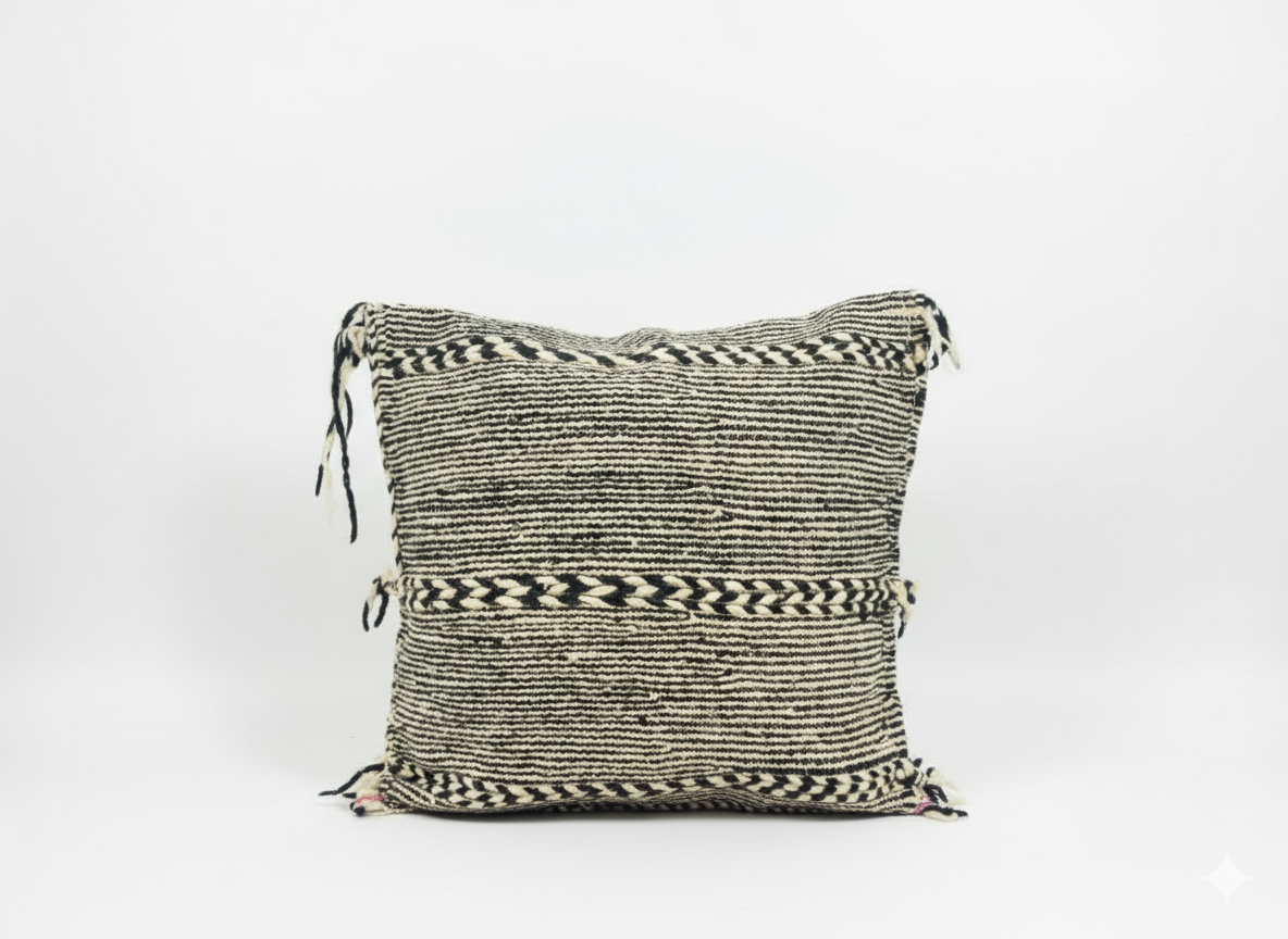 Front view of Tisra black and white Berber pillow handwoven in Moroccan wool