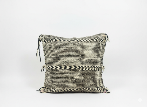 Front view of Tisra black and white Berber pillow handwoven in Moroccan wool