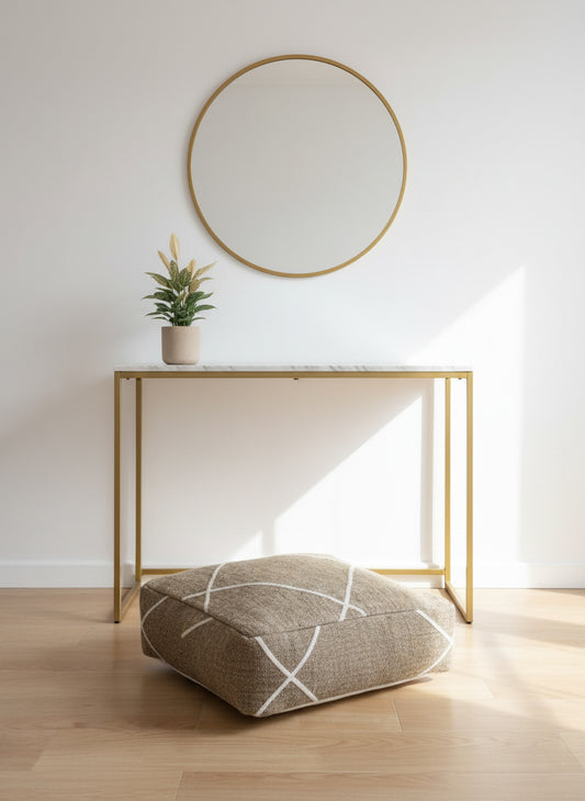 Handwoven brown wool pouf with minimalist white lines in modern home decor.