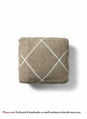Top view of brown Berber pouf featuring white geometric pattern.