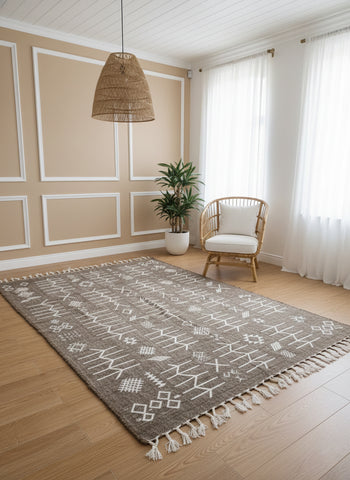 Gray Moroccan Idya rug with white Berber symbols in minimal boho room