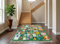 Green Berber rug with colorful motifs in entryway.