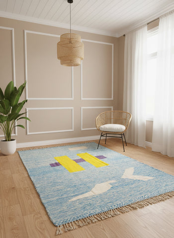 Blue Tafida rug with yellow and purple motifs in a modern minimal room.