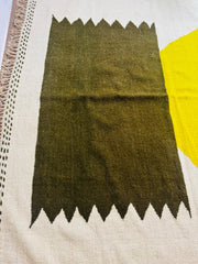 Handwoven Taznurt Berber rug with olive green and mustard yellow geometric pattern on a cream base