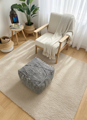 Berber Tamazirt pouf styled in a bright minimalist room.