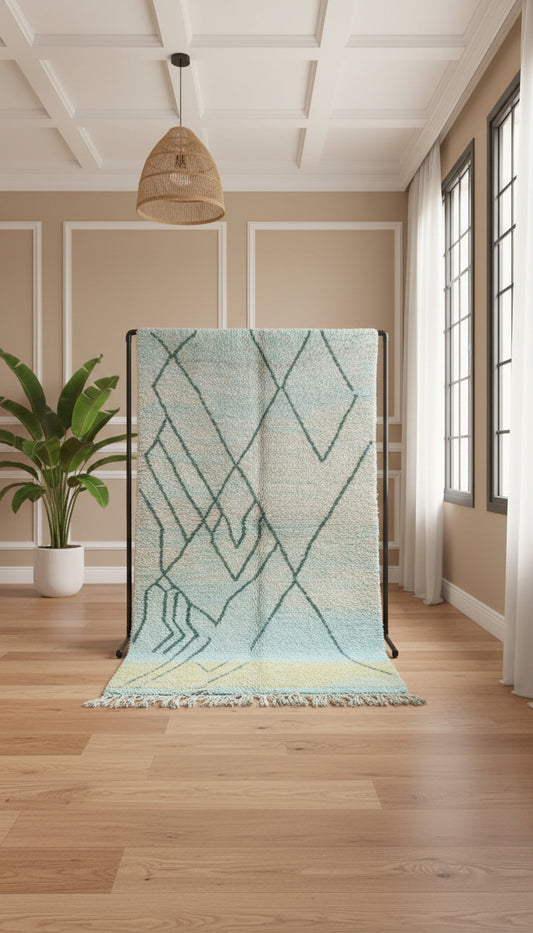 Moroccan Berber rug displayed upright showing pastel geometric design.