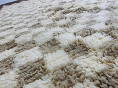 Close-up of the soft wool texture and handwoven checkered pattern of the Timzar Rug.