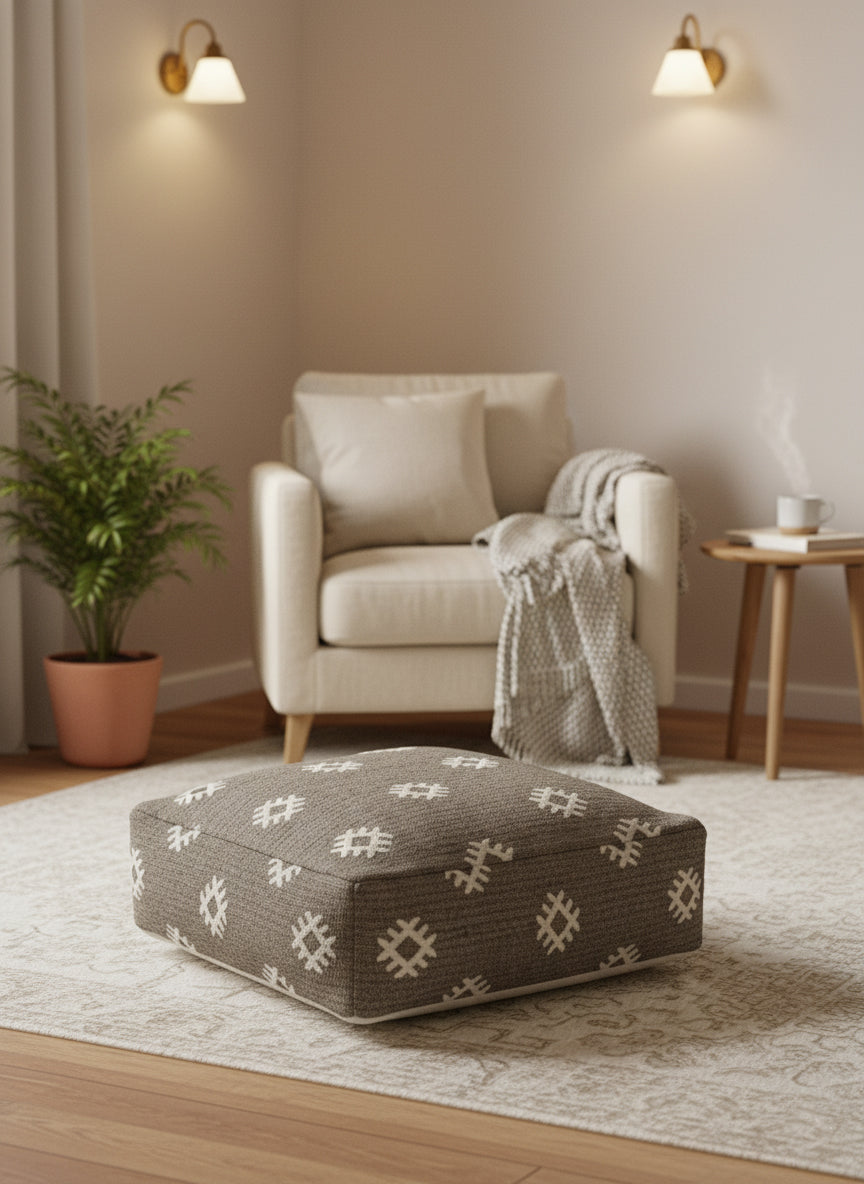 Handwoven wool pouf beside armchair