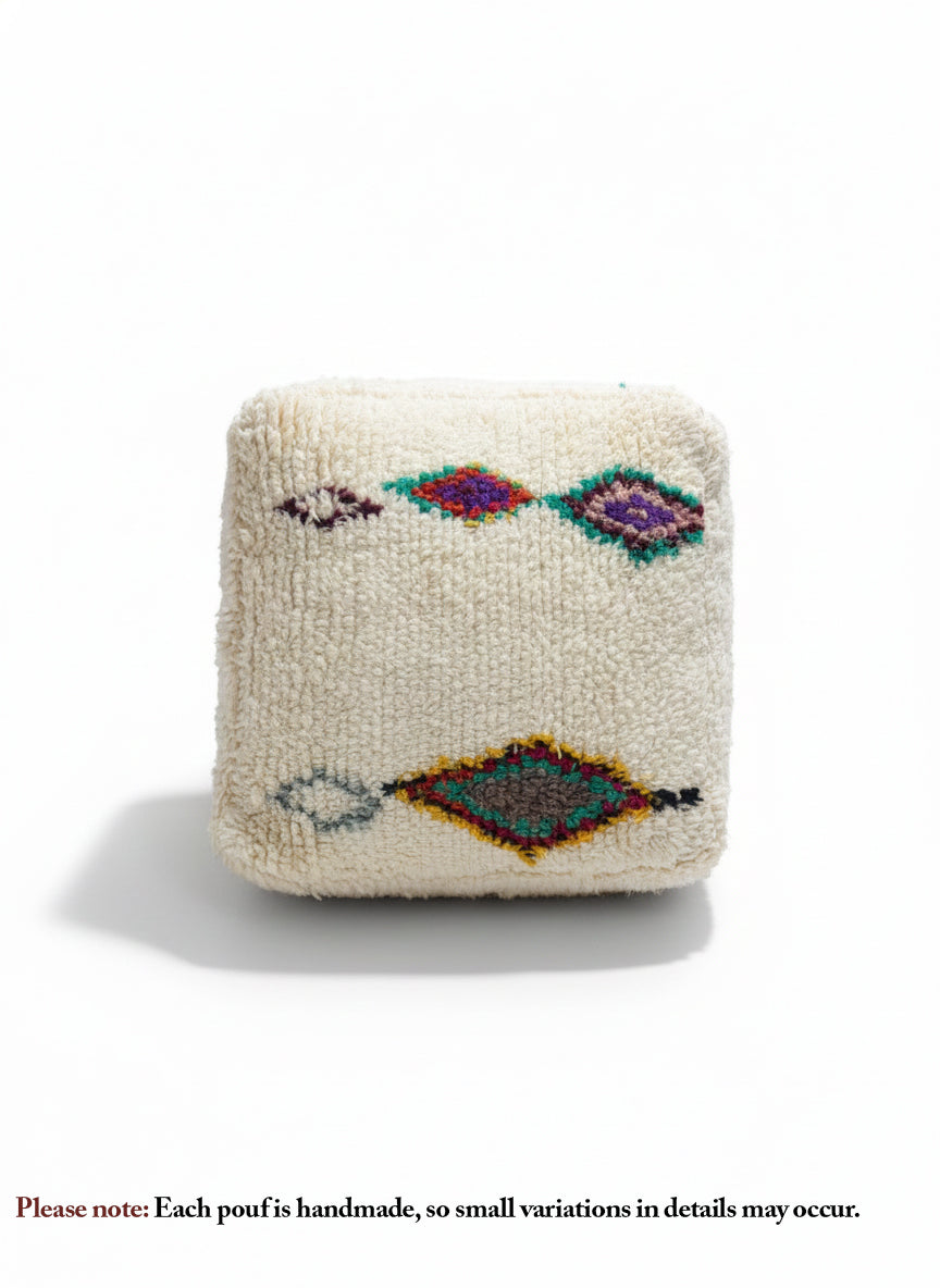 Front view of Amnay Berber pouf with diamond designs.