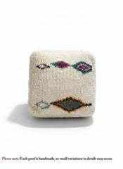Front view of Amnay Berber pouf with diamond designs.