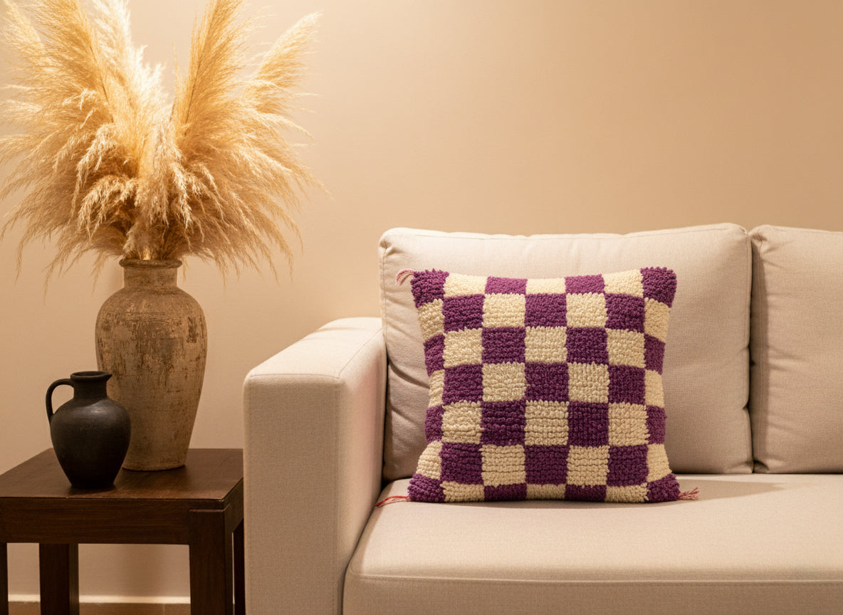 Handwoven purple and cream checker Berber pillow on beige sofa