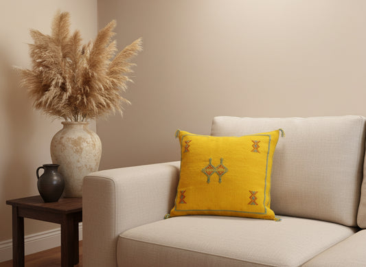 Bright yellow Berber cushion on a beige sofa in a warm neutral living room