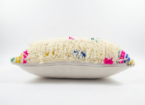 Decorative pillow with colorful embroidered design on a white background