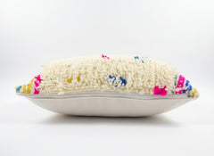 Decorative pillow with colorful embroidered design on a white background