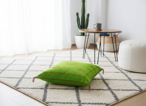 Tazgart Berber cushion on rug near cactus and wooden table