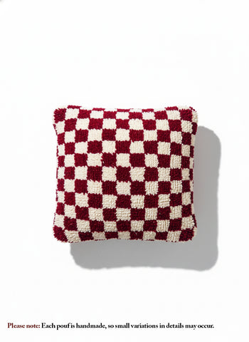 Handmade fuchsia and white Berber wool pouf with checker pattern on white background
