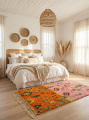 Pink and orange Berber rug in a cozy neutral bedroom.