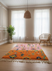 Pink and orange Berber Tafoukt rug in a bright living room