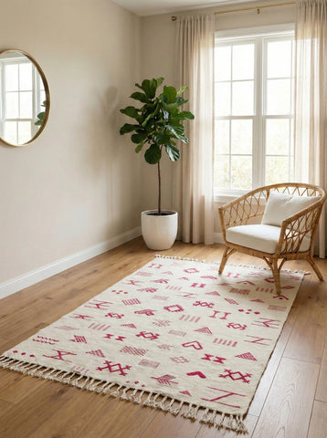 Cream Assya rug with pink Berber motifs in a cozy room