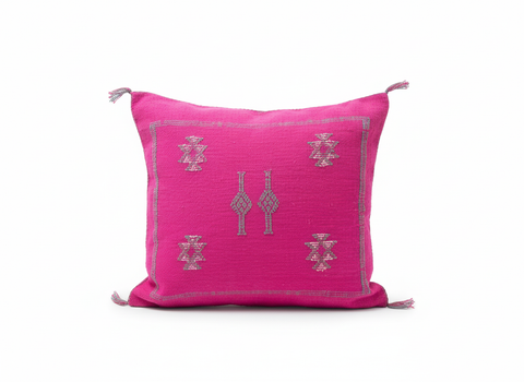 Fuchsia Taklit Berber cushion with silver Amazigh embroidery on white background