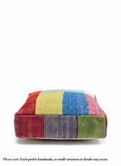 Close-up front view of a vibrant patchwork Moroccan wool pouf.