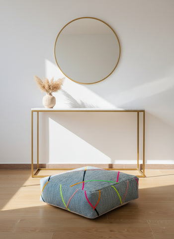 Blue Berber pouf under console table in bright room