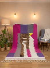 Handmade Tighilt Berber rug in fuchsia, purple, and cream with geometric pattern and fringes.
