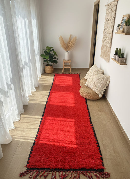 Handwoven red Berber Talwit runner rug with black border in a bright hallway
