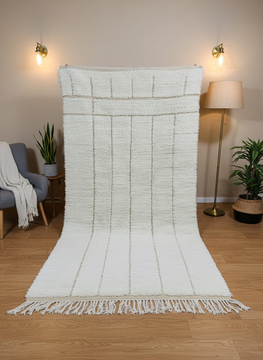 Full view of Tazgart Moroccan rug displayed vertically with tassels and modern décor.