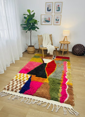 Bright multicolor Berber wool rug styled in cozy reading corner