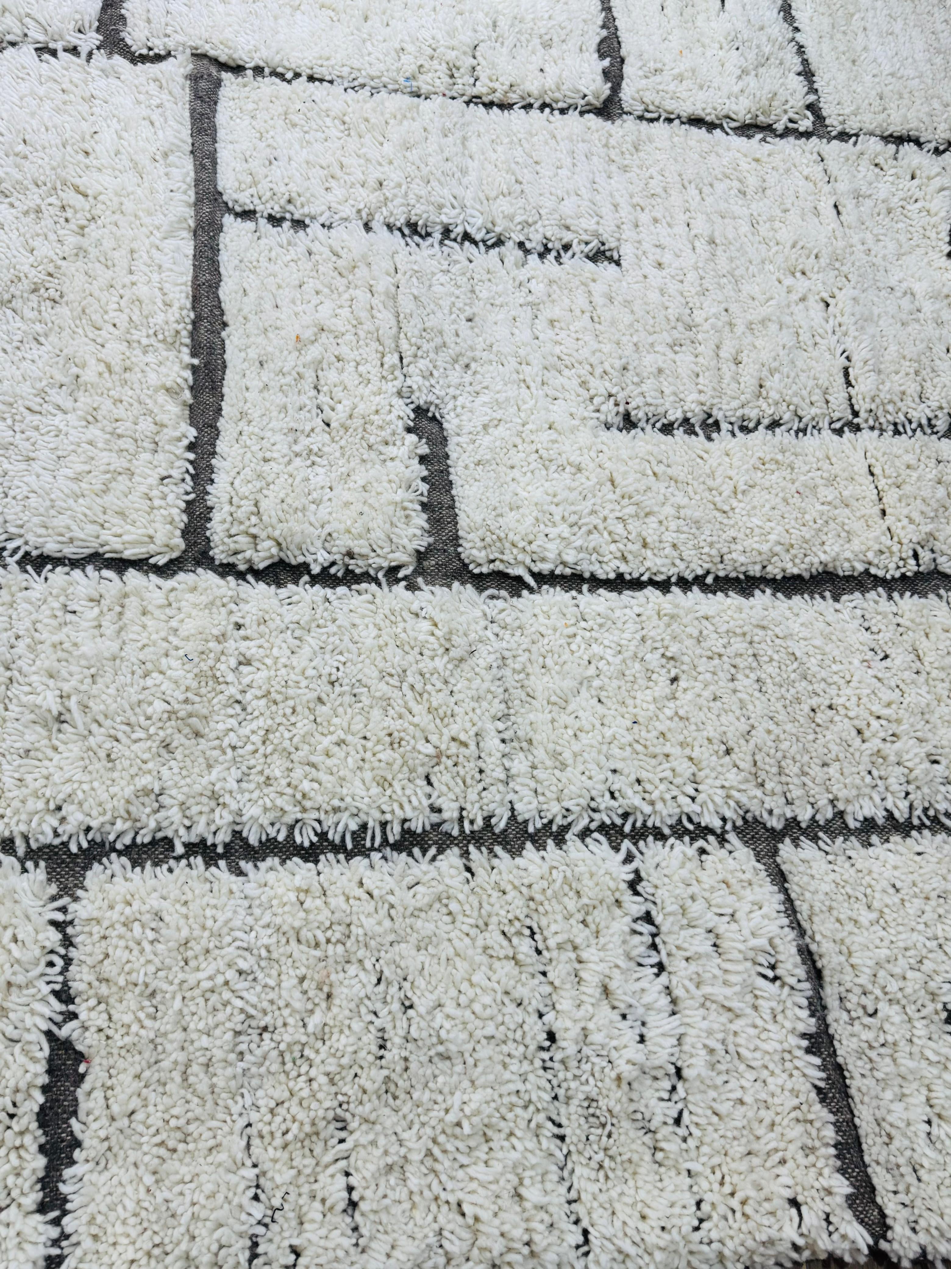 Handmade Tifawin Berber rug with cream wool and black geometric lines