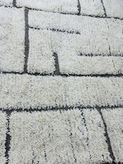 Handmade Tifawin Berber rug with cream wool and black geometric lines