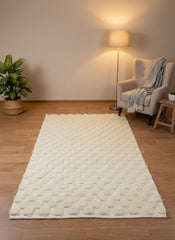 Thiya beige wool rug with diamond pattern in a cozy living room