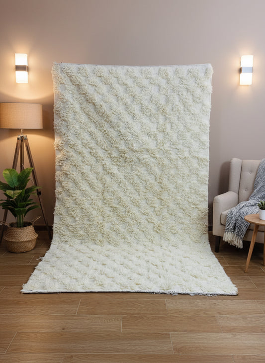 Handwoven Thiya Berber beige rug with soft geometric texture and fringed edges.