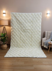 Handwoven Thiya Berber beige rug with soft geometric texture and fringed edges.