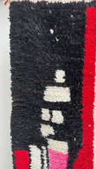 Close-up of the black wool texture and design details of the Tisili Berber rug.