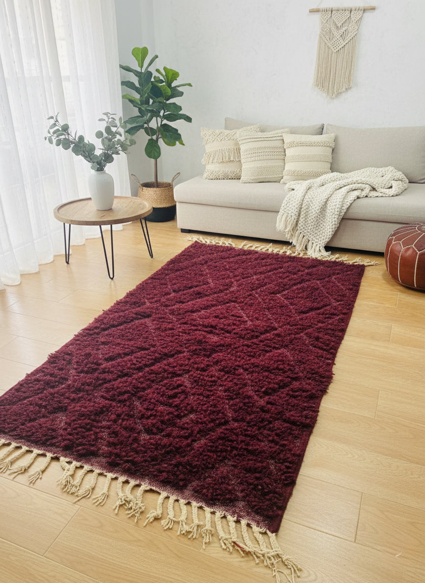 Plush Tafust Berber rug in rich plum wool on wooden floor