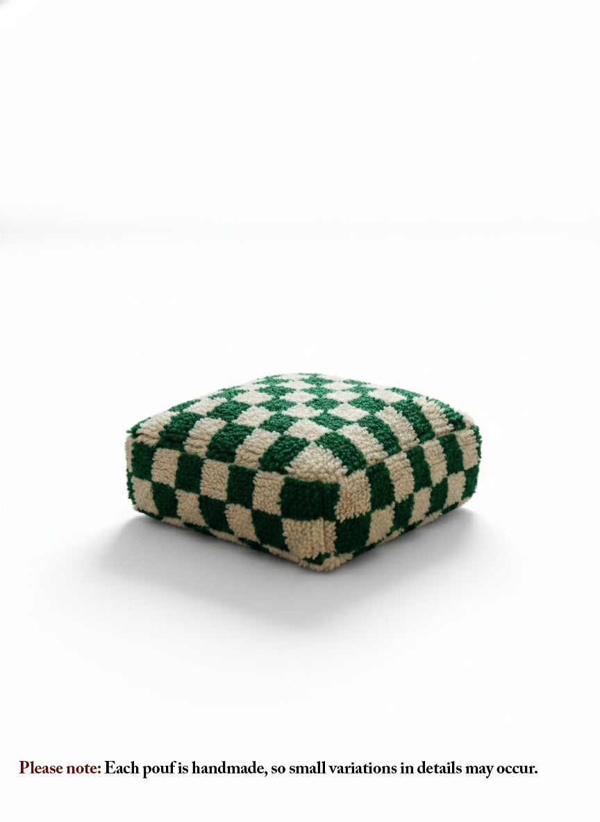 Green and cream checkerboard Berber pouf on white background.