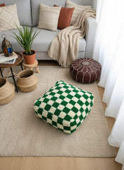 Elam green checker pouf styled in a cozy living room.