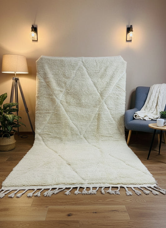 Beige Moroccan wool rug displayed vertically showing diamond design and tassel edges